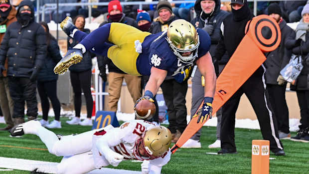 Nov 19, 2022; South Bend, Indiana, USA; Notre Dame Fighting Irish tight end Michael Mayer (87) dives for the pylon as Boston College Eagles defensive back Josh DeBerry (21) defends in the first quarter at Notre Dame Stadium. Mandatory Credit: Matt Cashore-USA TODAY Sports